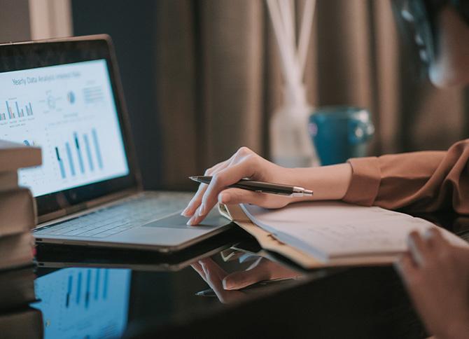 Person sitting at laptop looking at travel management report